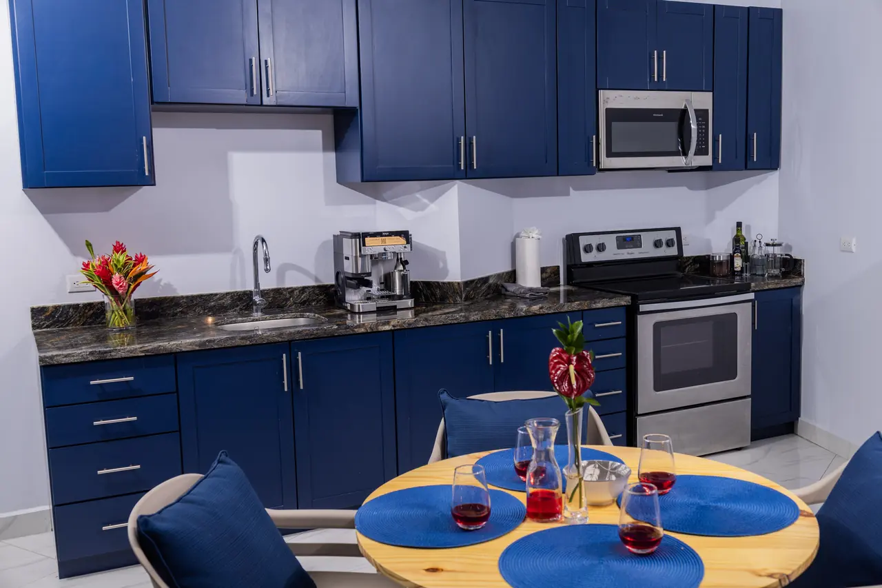 Fully equipped kitchen with blue cabinets in the Pacific Suite