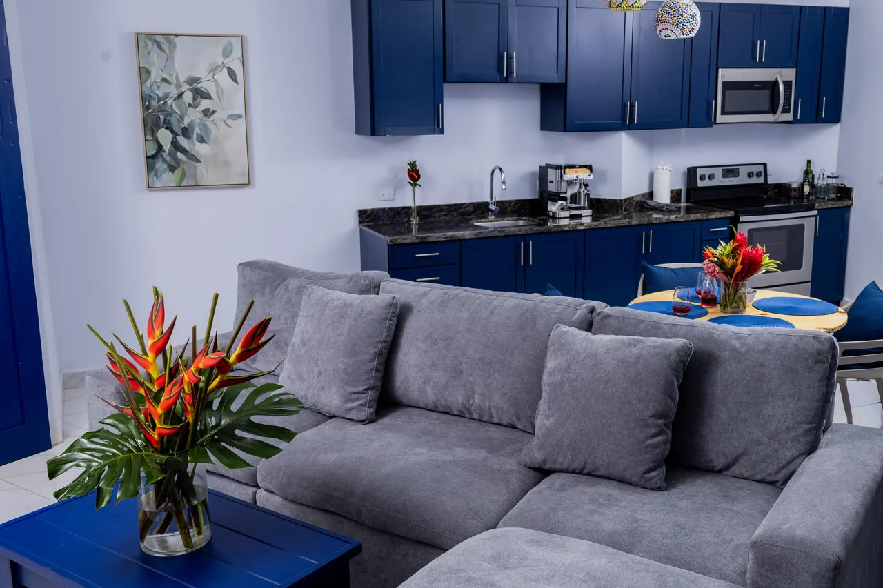 Living room with grey sofa and tropical flowers