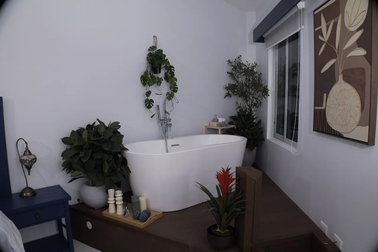 Freestanding bathtub surrounded by tropical plants