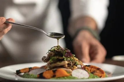 Private chef plating a gourmet dish