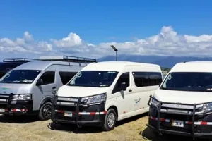 Private transfer vans parked by the coast