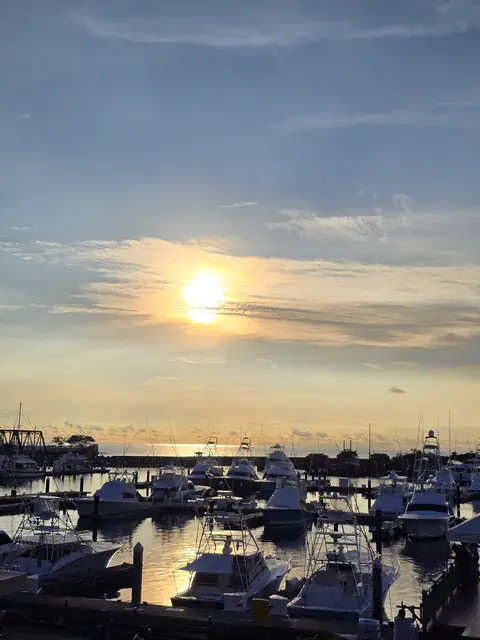 Sunset over a marina with boats